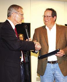 U.S. Rep. Brian Babin, left, is shown presenting a Congressional Coin and Certificate to Alan Sanford, who was named Citizen of the Year at the Silsbee Chamber of Commerce banquet last Friday night. Each of five award winners were presented the coin and certificate by Congressman Babin.