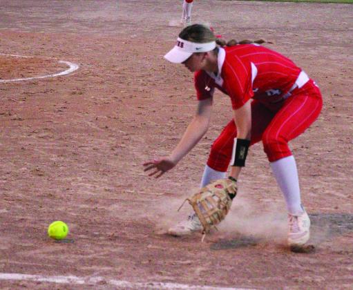 Kountze Lady Lion Laney Shivers scoops over and fields a ball which she fires to first for one of the final outs in the Lady Lions 10-2 victory over Buna. Danny Reneau photo