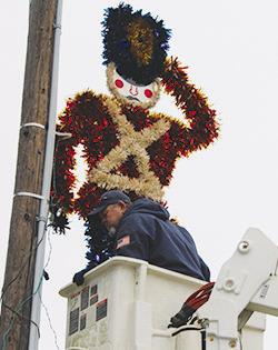 City workers were seen going up and down streets in Silsbee last Wednesday placing Christmas decorations for the soon approaching Christmas season. Dan Eakin photo