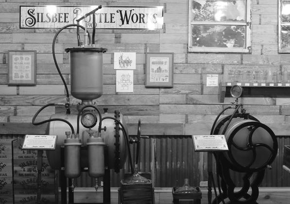 PHOTO BY CHRIS MECHE, THE BEE Examples of the machines used in bottling soda in Silsbee from 1909-1913 on display at the Ice House Museum.