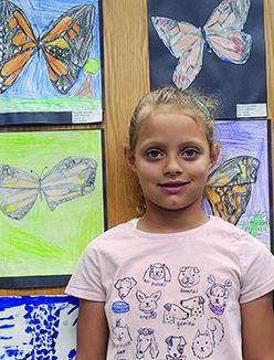 Kingston Atwood, age 6, and Brooklyn Atwood, age 7, stand beside their art work which is among the art work of several students being displayed this month at the Silsbee Public Library.. Photos courtesy of Barri Hoffman