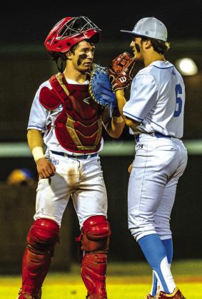 Lumberton catcher Gavin Harmse takes a time out to speak with pitcher Canton Dinnigan during the Raiders’ battle with Hampshire Fannett on Feb. 20.The Raiders dropped this game by a 4-2 score. Photo by Brent Guidry