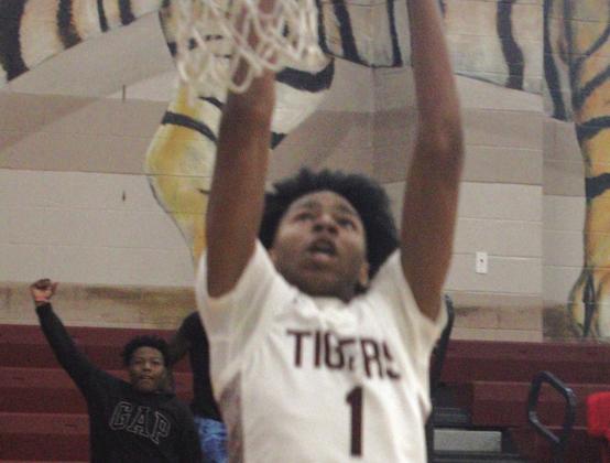 Silsbee’s #1 Jared Harris dunks the ball in the game against Pasadena Dobie.Harris is one of the most highly recruited high school players in Texas. He scored 23 points in this game.