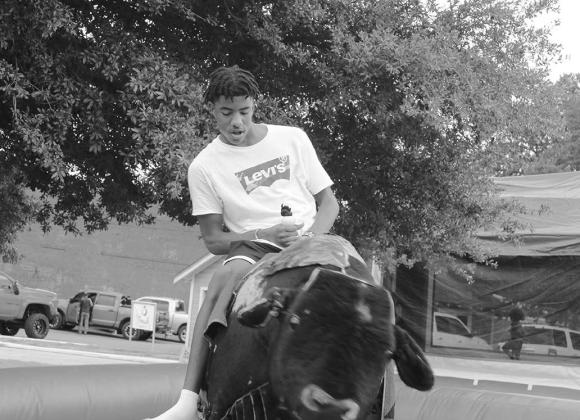Kaiden Harper riding a mechanical bull at Tiger Prowl. PHOTO BY CHRIS MECHE, THE BEE