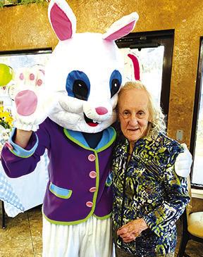 The Easter bunny made lots of friends who were eager to shake his hand or as seen pictured here get a hug as Silsbee Oaks resident Judith Parker did.