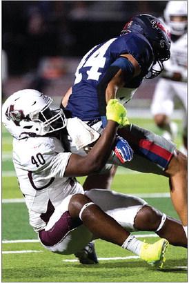 Jayron Williams making the tackle against Hardin-Jefferson. Photo by Brent Guidry