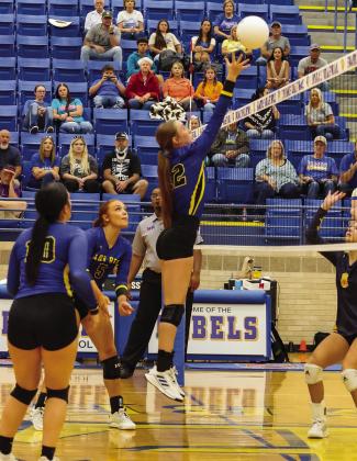 Evadale Lady Rebel Madison Riedinger tips the ball back to a West Hardin player in a volleyball game Friday night in Evadale.The Lady Rebels won 3-2