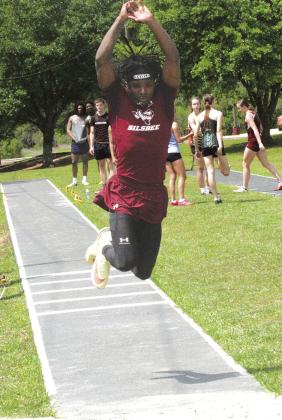Raydrian Baltrip flies with a hop,skip and jump on his way to a near record leap in the triple jump at the district track meet. The outstanding Silsbee senior was the high point man in the track meet. He won the triple jump with a leap of 47’3”, the long jump at 22’2” and won the 200 meter dash. In addition he ran legs on the 4x100 and 4x200 meter relays that both placed third. Danny Reneau photo