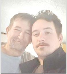 A handsome Justin Davis, at right, is seen in a recent photo posing with his father Bronson Davis.