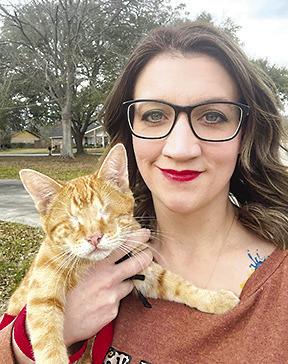 Lexi Swindell, founder of the Satsuma Valley Cat Coalition (SVCC), holds Milo,a tabby cat whose eyes had to be removed because of a serious disease. Courtesy photo