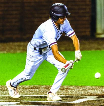 Evan Welch lays down a bunt during the Tigers win over Hamshire- Fannett. The Tigers had three infield hits during the battle with the Longhorns.This year they have mastered the art of combining small ball with an excellent defense and good pitching to advance in the playoffs. Photo by Brent Guidry
