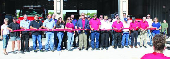 Members of the Silsbee Fire Department ESD6 board of directors and others lined up to cut the ribbon for the grand opening of the new state-of-the art fire station at FM 418 and Fifth Street in Silsbee. See more fire station photos page 8B. Dan Eakin photo