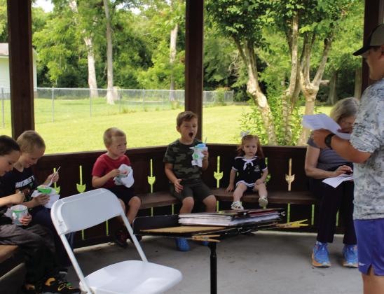 Children enjoyed a snow cone while at the same time listening to a story being read by UIL oral reader Bailey Blanchard in the gazebo beside the Kountze Public Library. Photos by Dan Eakin