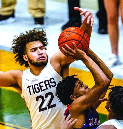Mason Brisbane (22) is about to block a shot against the Hardin Jefferson Hawks. This unselfish senior was willing to come off the bench and make contributions to the Tiger team throughout the season.