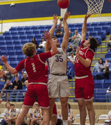 Evadale Rebel Junior Warren Brewer (35) goes up for a 2 point shot against the Deweyville Pirates.The Rebels beat the Pirates 104-21 and are now 9-0 in district action Julie Isbell photo