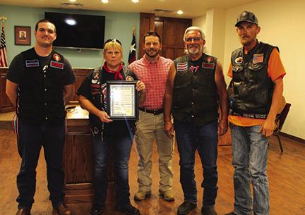 Silsbee Mayor Kevin Garner, center, presented a proclamation to a group of motorcycle riders proclaiming the month of May as Motorcycle Awareness Month and urging motorists to carefully watch out and protect motorcycle riders on the highways and roads.