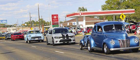 Just a few of the long line of antique cars are seen coming down Fifth Street at the conclusion of the Cruise’n Silsbee event last Saturday. Dan Eakin photo