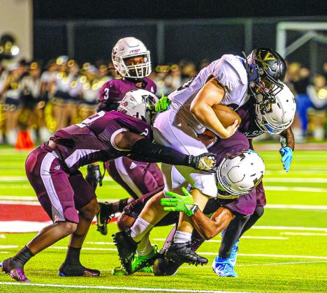 Several Silsbee Tigers gang up on Vidor Pirate during the season opener in Silsbee.The Tigers won 35-14. Julie Isbell Photo