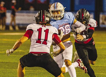Lumberton Raider Chase Williams runs hard with one would be tackler in front of him and another behind him. He carried the ball 17 times for 96 yards and one touchdown against Huffman Hargrave in Lumberton Friday night.The Raiders won, 46-14. Brent Guidry photo