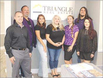 Members of the staff of Triangle Real Estate are, from left, Ryan Brown, Michael Buffington, Chelsea Hughes, Rebecka Sellers, Autumn Rodriquez, Ben Rodriquez (owner), and Tobetha Rodriquez. Dan Eakin Photo