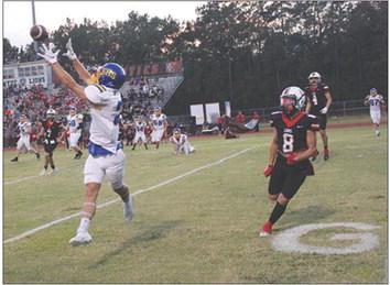 Evadale Rebel Devin Terrell catches a pass on the four yard line and takes it over to score the second of his three touchdowns against Kountze Lions.The Lions won 70-20. Dan Eakin photo