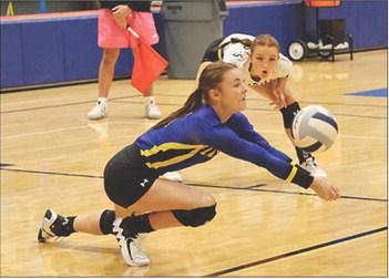 Evadale Lady Rebel Karli Hoke shows an opponent how to dig a spiked ball in a recent game. Melissa Reidinger photo