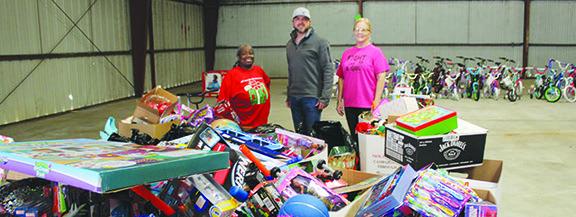 From left, volunteers Donita Banks, Curt Woodard and Jeannie Harrison stand among many toys already donated to the official United States Marine Corps Reserve of Hardin County Toys for Tots. More toys are needed to serve many Hardin County boys and girls awaiting Christmas morning to unwrap gifts and find bicycles from Santa by way of Hardin County Toys for Tots.Without the generous hearts and creative toy drives of many businesses collecting,donating,and serving,this would not be possible. Dan Eakin photo