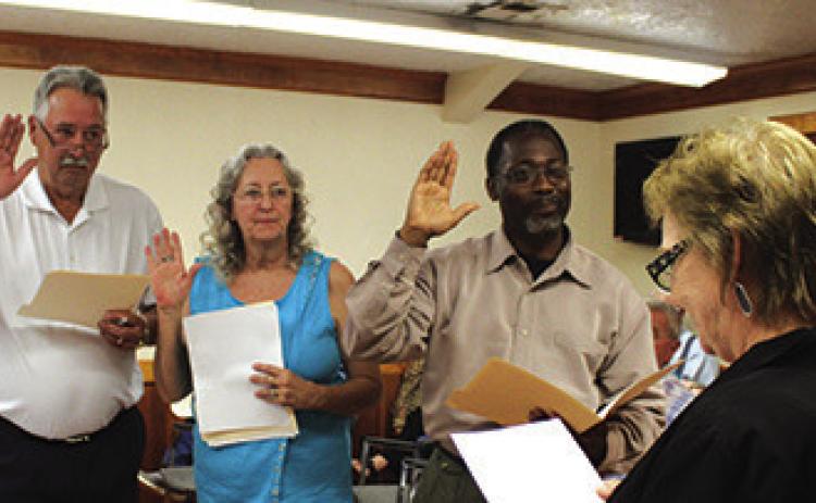 From left, Jim Shirey who defeated Mary Adams, Barbara Greer who ran unopposed and Glenn Matthews who was re-elected are administered the oath of office by Kountze Municipal Judge Barbara Malone near the beginning of the regular meeting of the Kountze City Council last Thursday afternoon.