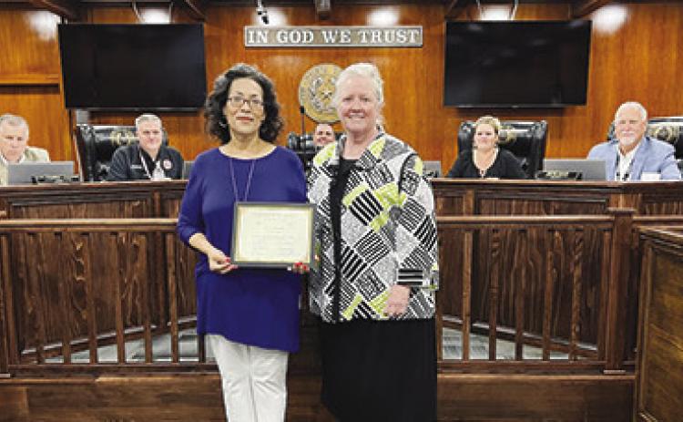 Irene Brooks, left, Hardin County Tax Deputy who is retiring after serving nine years of service to the county, stands with Tax Assessor-Collector Shirley Cook after having been presented with a certificate in her honor which was signed by the county judge and each county commissioner. Seated from left are L.W.“Nubbin” Cooper Jr., Pct. 1 commissioner; Chris Kirkendall, Pct. 2; County Judge Wayne McDaniel; Amanda Young, Pct. 3 and Ernie Koch, Pct. 4. Courtesy Photo