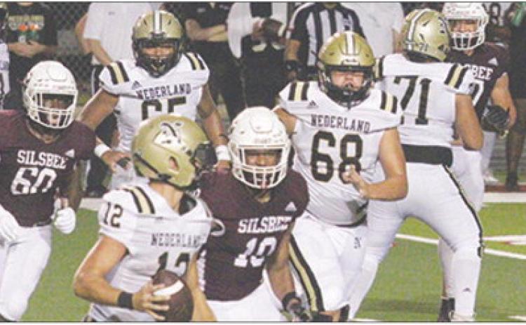 Silsbee Tigers Maddox Shields (60) and Ka’leb Gaines (10) close in on the Nederland quarterback during last Friday night’s game.The Tigers won, 49-0. Danny Reneau Photo