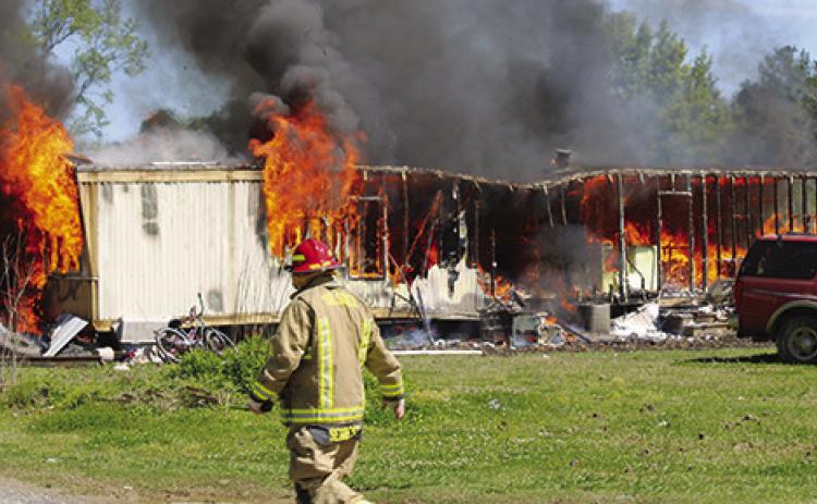 A woman and her son narrowly escaped when the mobile home they were living in the 8500 block of Bussey Road north of Silsbee caught fire shortly before noon Tuesday. Dan Eakin photo