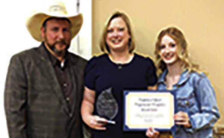 Brandi Stutts, center, was recognized as Citizen of the Year at the Kountze Chamber banquet.At left is Steven Stutts and at right is Amberly Stutts.