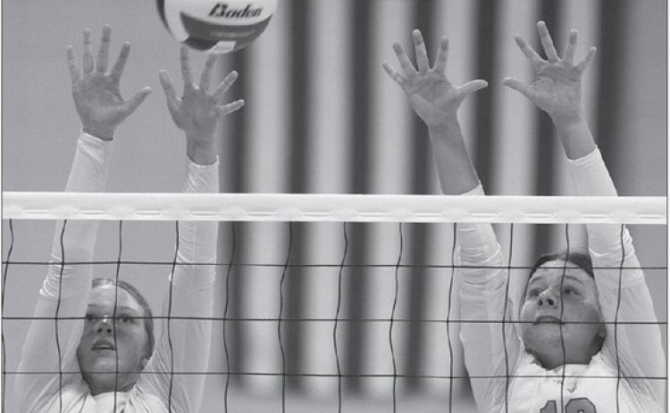 Jaycee Spears and Emilie Taylor go up for a block against WOS.