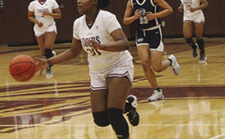 Ayana Washington dribbles the ball up floor with Kearstyn Hall (2) and Ca’Draine Martin following. Silsbee finished District play with a perfect 12-0 record. The Lady Tigers are now 26-3 this season. Dan Eakin photo