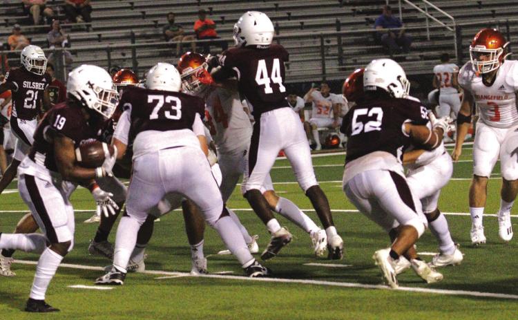 The Silsbee High School offensive line has the Orangefield defense sealed off.The key blockers are Xander Horton, Kealin Whittle and Oscar Perez. Kyle Arion slips down the line looking for a hole to power through the defense. This action took place during the Tigers’ scrimmage with Orangefield. Photo by Danny Reneau