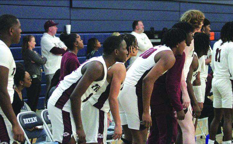 Members of the Silsbee Tigers basketball team watch intently as their fellow teammates battle the Booker T. Washington Eagles last Saturday at Bryan High School.The Tigers played their hearts out but lost 76-70 in the regional final. Photo by Danny Reneau