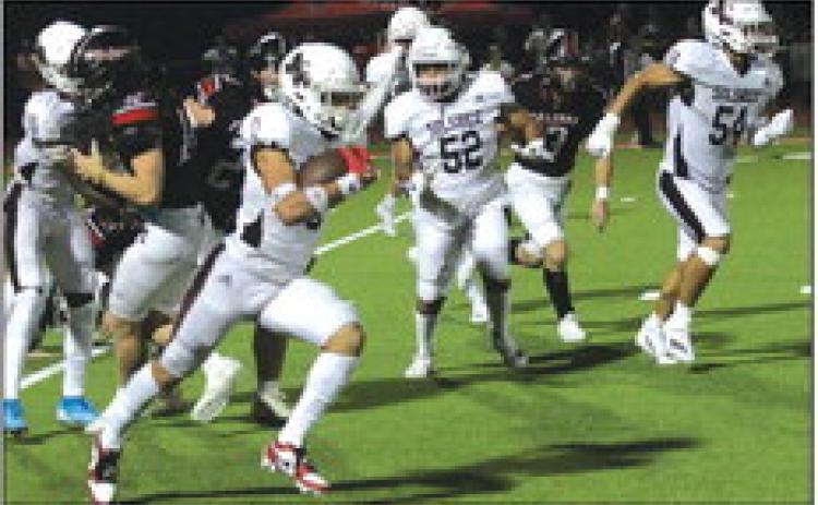 Silsbee Tiger Trei’ Kibbles picks up some yardage while Oscar Perez (52), Braden Beasley (54) and others run interference against Huffman Hargrave.The Tigers won 41-14. Danny Reneau photo