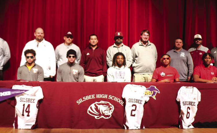 The Silsbee High School football players signing letters of intent include: (front row left to right) Mason Brisbane at University of Mary Hardin Baylor, Max Brisbane at the university of Mary Hardin Baylor, Kevin Martin at Hardin Simmons University, Jerrick Harper at Trinity Valley Junior College and Jayron Williams at Lamar University. The coaches (standing left to right) Trent Jones,Randy Smith,Keaton Baker,Radi Verrett, Michael Nelson, Cole Burrus, Corey Harrison, Jarrod Morris and Ronald Loftin.