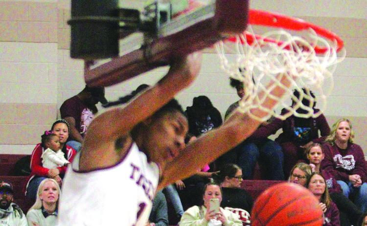 Jarad Harris slams home a dunk during the early stages of the Tigers win over Bridge City on Friday. He took scoring honors in the game with 22 points. Harris is expected to sign a letter of intent to play basketball at the University of Memphis this week. Danny Reneau photo