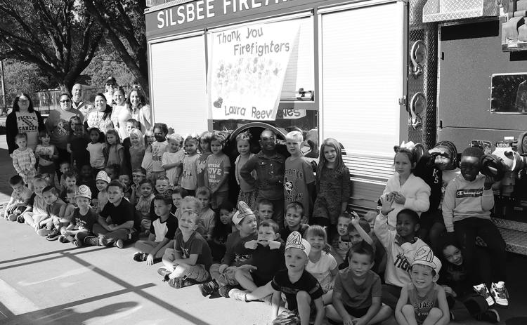 Students and staff of Laura Reeves Primary posing in front of fire truck with Mark Seagrast and Danny Tarkington for fire prevention week. Photo courtesy of Silsbee ISD