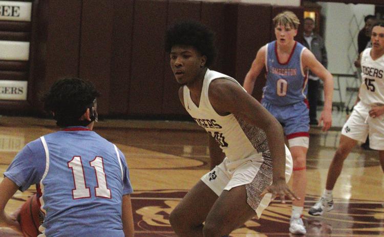 Eli Quinn (11) grabs a loose ball and is looking for someone to pass to as Billy Boulwen (30) of Silsbee defends. Rysen Hooker (0) appears to be the most available teammate. LaMarcus Bottley (15) is in the background playing defense. Photos by Danny Reneau