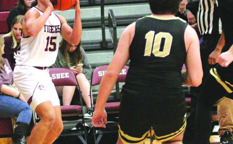 Lamarcus Bottley has been the Tigers long range shooting guru.He has been nailing three point shot after three point shot all during district play. In one recent game he made eleven three point baskets which was one short of the school record. Here he is about to put one up against Vidor.