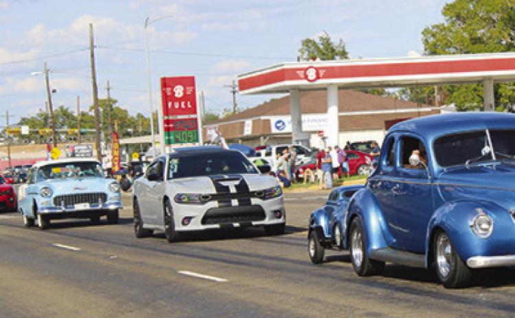 Just a few of the long line of antique cars are seen coming down Fifth Street at the conclusion of the Cruise’n Silsbee event last Saturday. Dan Eakin photo