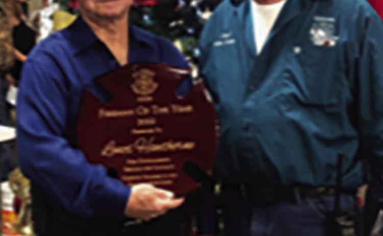 Lenox Hawthorne was honored as the Silsbee Fireman of the year by the members of the Silsbee Fire Department. Robin Jones presented Hawthorne with his trophy. Photo courtesy Silsbee Fire Department