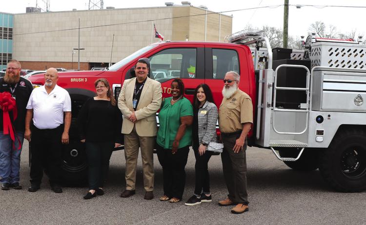 Representatives from Hardin County met with members of the general land office for a ribbon cutting and to turn over the keys to a new high water fire truck that was presented to ESD District 3. ESD District 1 and 6 will also receive new trucks similar to this one. Photo by Danny Reneau