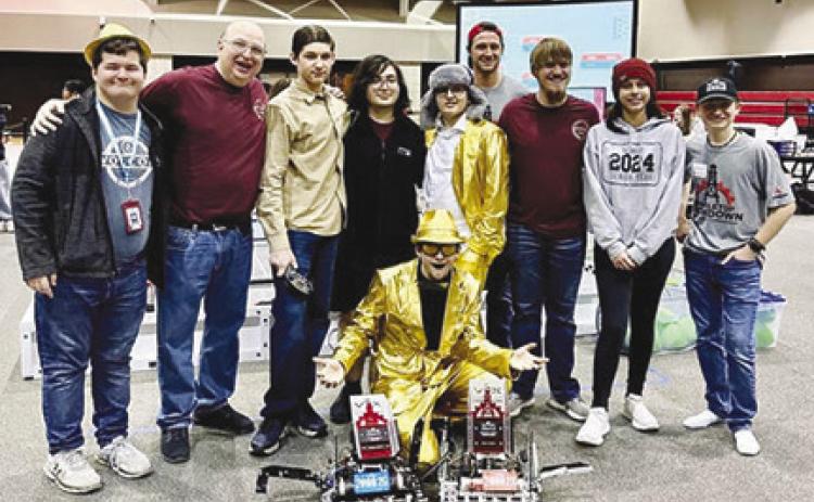 SHS Gold! members shown above are, from left, Collin Sammons, Coach Vic Miller, Sawyer Wimer, Audie Miller, Bryce Pyne,Tristin Bell, Aubrey Durant, and Nathan Pyne (in front). In gray shirts are SHS robotics alumni and current Lamar students Bobby Barton and Reese Rodgers who were tournament organizers and officials. Courtesy photo