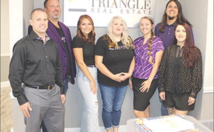 Members of the staff of Triangle Real Estate are, from left, Ryan Brown, Michael Buffington, Chelsea Hughes, Rebecka Sellers, Autumn Rodriquez, Ben Rodriquez (owner), and Tobetha Rodriquez. Dan Eakin Photo